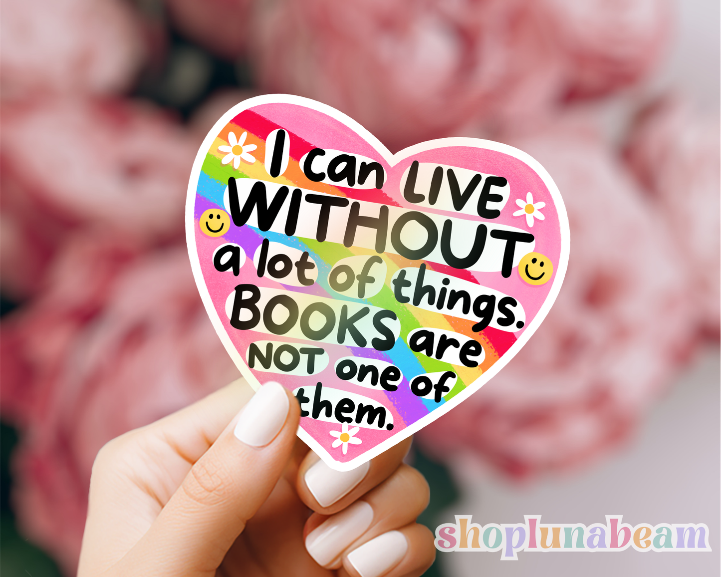 Heart-shaped sticker with a quote about books held by a hand, with a blurred background.