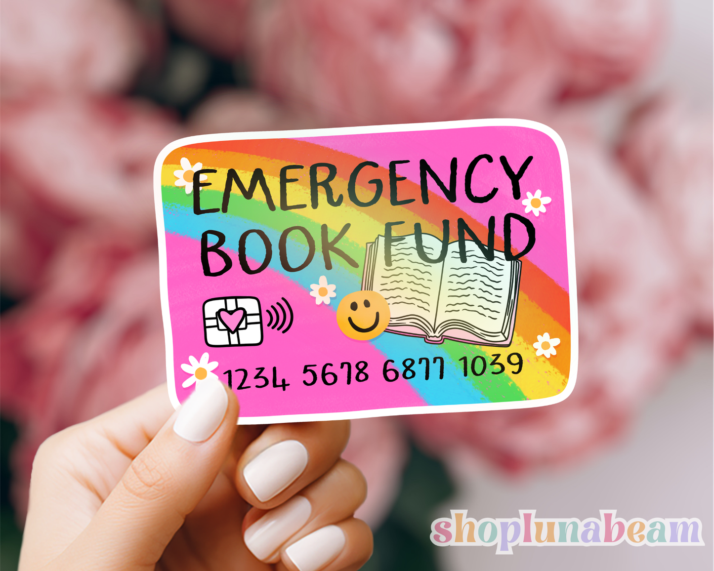 Colorful 'Emergency Book Fund' card held by a hand with a blurred background