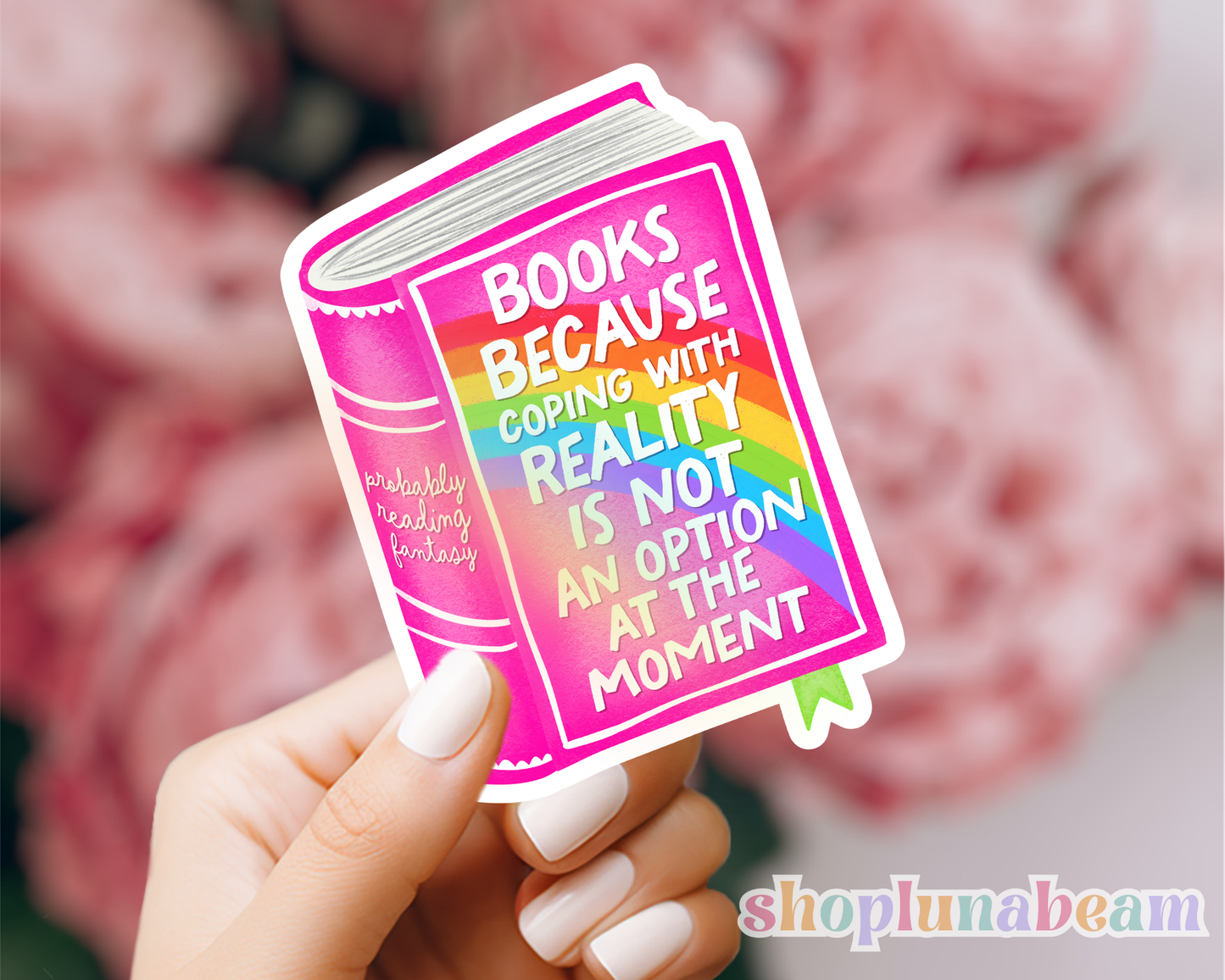Sticker of a book with a colorful message held by a hand, with a blurred background and 'shoplunabeam' branding.