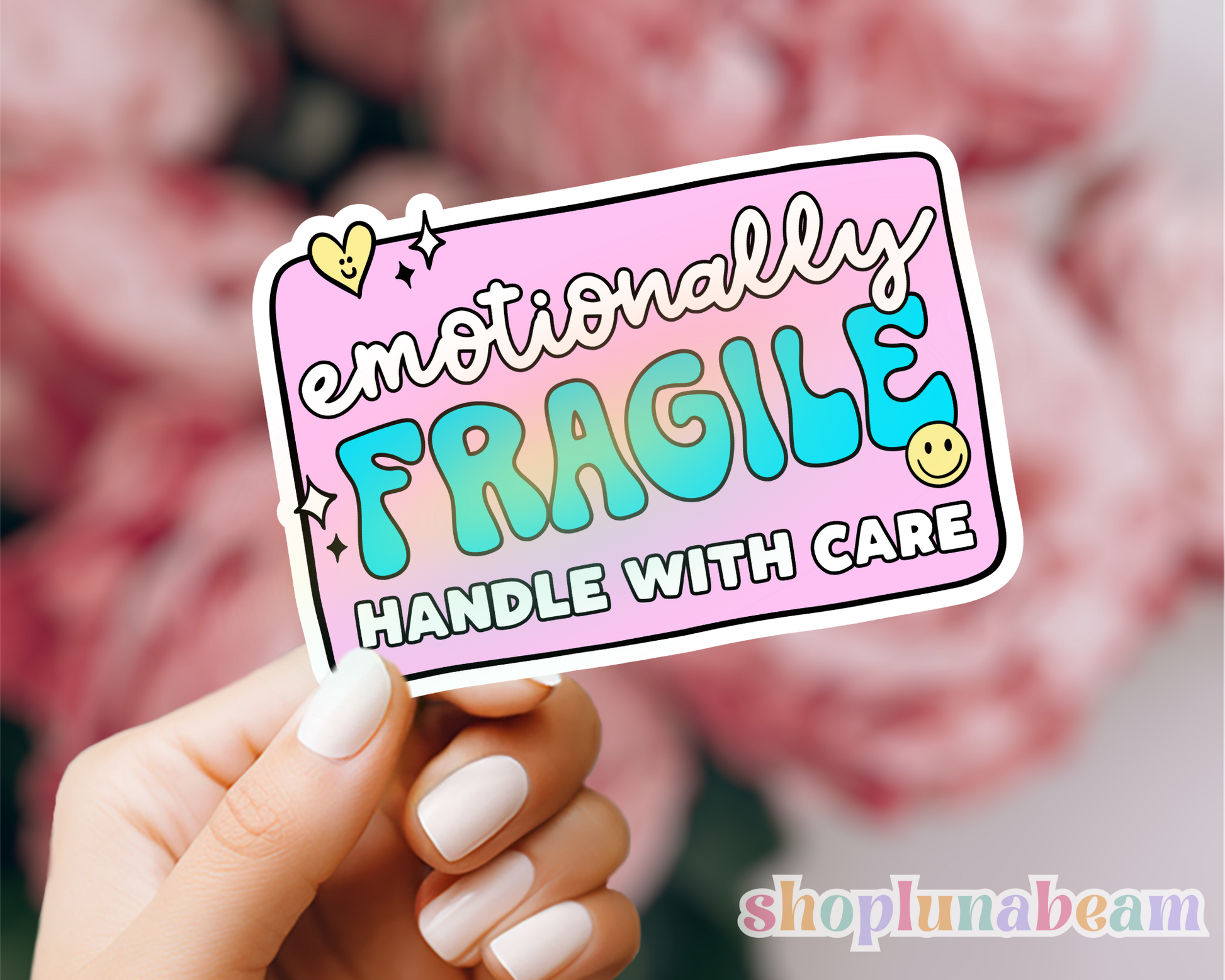 Hand holding a 'emotionally fragile handle with care' sticker with a blurred background
