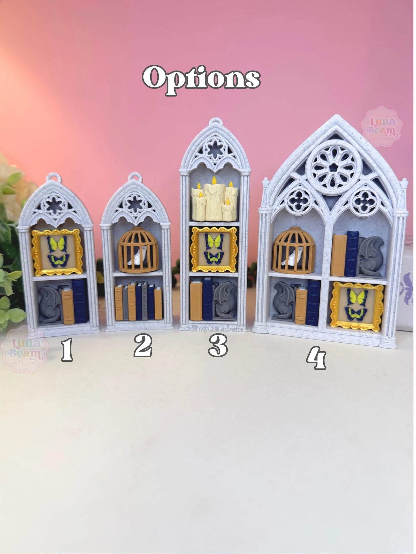 Four gothic-style display cases with different interior arrangements on a pink background.