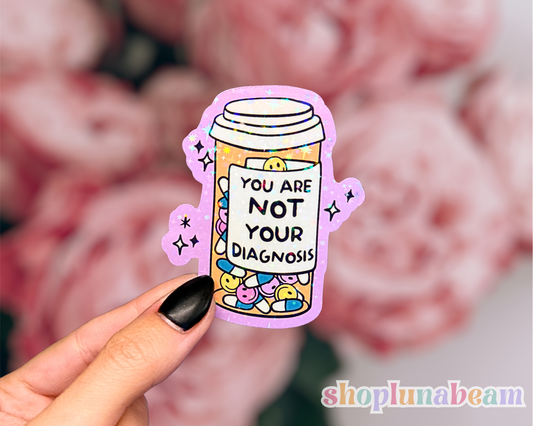 Sticker with pill bottle design and text 'You are not your diagnosis' 
